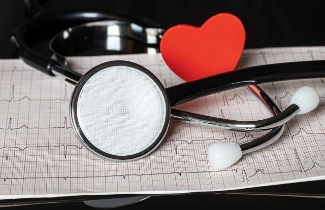 Stethoscope and heart icon on ecg paper