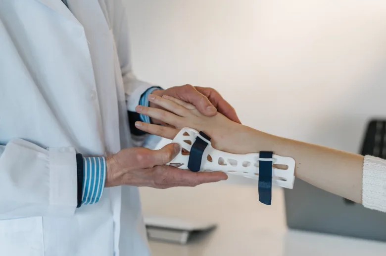 Doctor examining wrist brace