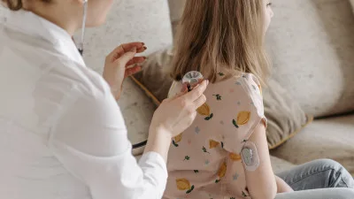 Medical professional checking patient's glucose monitor
