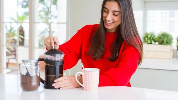 Woman making coffee with french press