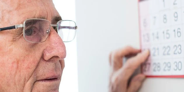 Elderly man with calendar