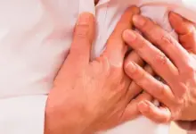 Hands clutching chest