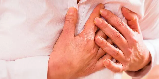 Hands clutching chest